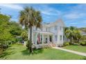 Attractive two-story home with a front porch, green lawn, and mature landscaping at 216 Freeman St, Mount Pleasant, SC 29464