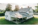 Rear exterior showcasing the metal roof and a convenient covered parking area at 21877 Lowcountry Hwy, Ruffin, SC 29475