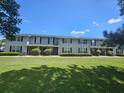 Charming two-story townhome featuring a well-maintained lawn and classic architectural details under a sunny sky at 2494 Etiwan Ave # 3I, Charleston, SC 29414