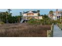 Inviting rear exterior featuring a covered porch, outdoor seating, and scenic views at 2705 Parkers Landing Rd, Mount Pleasant, SC 29466