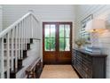 Inviting foyer featuring a staircase, wood floors, and natural light at 31 Seagrass Ln, Isle of Palms, SC 29451