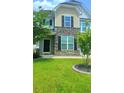 Charming home featuring a manicured lawn and stone facade with a tasteful front door at 322 Braken Fern Rd, Moncks Corner, SC 29461
