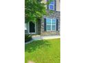 Exterior shot of a home featuring a manicured lawn and stone facade at 322 Braken Fern Rd, Moncks Corner, SC 29461