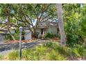 Charming exterior of home, shaded by mature trees, features a welcoming entryway and lush landscaping at 341 Seabrook Island Rd, Seabrook Island, SC 29455