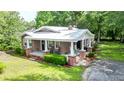 Lovely single-story brick home with a covered porch, manicured lawn, and a metal roof at 416 Altman St, Moncks Corner, SC 29461