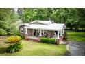 Beautiful brick home with a metal roof, cozy front porch, and landscaped yard at 416 Altman St, Moncks Corner, SC 29461
