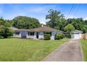 Inviting home with a well-manicured lawn, long driveway, and a detached garage at 422 Geddes Ave, Charleston, SC 29407
