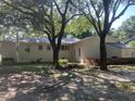 Exterior back view of home with brick details, mature trees, and AC unit at 874 Evans Rd, Charleston, SC 29412