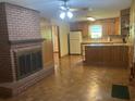Open-concept living room features hardwood floors, a brick fireplace, and a view of the kitchen at 874 Evans Rd, Charleston, SC 29412