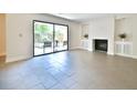 Bright living room featuring a fireplace, tiled floors, and sliding door to the patio at 93 Ashley Hall Plantation Rd # 6, Charleston, SC 29407