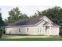 Beautiful home featuring white siding, a two-car garage, manicured lawn, and lush trees at Blvd, Moncks Corner, SC 29461