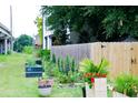 Spacious backyard with a privacy fence, garden area, and lush lawn for outdoor enjoyment at 10 Riker St, Charleston, SC 29403