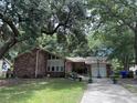 Charming single-story brick home featuring a two-car garage, a driveway, and a well-manicured front yard at 1056 Yorktown Dr, Charleston, SC 29412