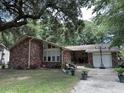 Charming single-story brick home with a two-car garage and a well-manicured front yard with a walkway at 1056 Yorktown Dr, Charleston, SC 29412