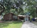 Charming single-story brick home featuring a two-car garage, a driveway, and a well-manicured front yard at 1056 Yorktown Dr, Charleston, SC 29412