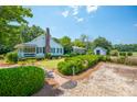 Well-maintained home and yard with neatly trimmed hedges and a brick walkway at 1133 Highway 311, Cross, SC 29436