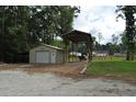 Detached garage and covered shed sit on a well maintained lot at 123 Christina Ln, Summerville, SC 29483