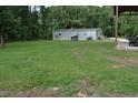 Large lawn with scattered trees, featuring an outbuilding with a spacious covered area at 123 Christina Ln, Summerville, SC 29483