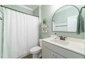 Clean bathroom with a stylish vanity, modern fixtures, and a shower with white curtain at 1250 Hammrick Ln, Johns Island, SC 29455