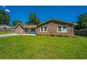 Lovely single-story home with a spacious lawn and mature trees in a serene setting at 127 Rahway Rd, Goose Creek, SC 29445