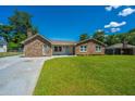 Well-maintained home showcasing a lush lawn and a classic brick exterior at 127 Rahway Rd, Goose Creek, SC 29445