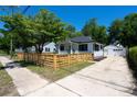 Well-maintained home featuring a detached two-car garage, a wooden fence, and a convenient concrete driveway at 1430 E Montague Ave, North Charleston, SC 29405