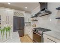 Modern kitchen with stainless steel appliances and a stylish range hood at 15 Dewey St, Charleston, SC 29403