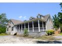 Beautiful home featuring a large screened-in porch, offering a comfortable outdoor living space at 153 Willow Brook Way, Cordesville, SC 29434