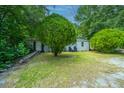 Charming single-story home with mature trees and a well-maintained front lawn at 1612 Evergreen St, Charleston, SC 29407