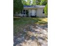 View of a single-story home with a well-maintained front yard and white exterior at 1612 Evergreen St, Charleston, SC 29407