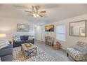 Bright living room featuring cozy seating, a wall-mounted TV, and stylish decor at 1617 Refuge Run, Charleston, SC 29412