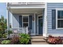 Inviting covered porch with rocking chairs, tasteful plants, and a freshly painted front door at 2017 Geranium Ln, Johns Island, SC 29455