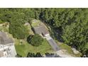 Aerial view of a home with a long driveway surrounded by lush greenery, creating a private setting at 214 Deer Ridge Court Ct, Huger, SC 29450