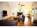 Warm living room showcasing hardwood floors, a cozy fireplace, and ample natural light at 2206 Hunter Creek Dr, Charleston, SC 29414