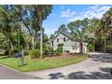 Well-maintained home showcasing lush landscaping, a private driveway, and classic shutter accents at 2340 Marsh Hen Dr, Seabrook Island, SC 29455