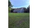 Spacious backyard featuring a well-maintained lawn and a blue one-story house at 2460 Bama Rd, Cottageville, SC 29435