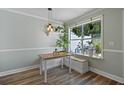 Light-filled dining area with a table, bench, and large window at 252 Howle Ave # C3, Charleston, SC 29412