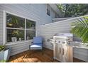 Cozy patio with a grill, comfortable seating, and lush greenery at 252 Howle Ave # C3, Charleston, SC 29412