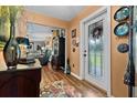 Inviting foyer boasts wood flooring, a decorative rug, and a glass-paneled front door at 274 Harvest Rd, Moncks Corner, SC 29461