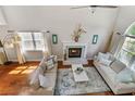 Open-concept living room with vaulted ceiling, fireplace, hardwood floors, and stylish decor at 339 Mount Royall Dr, Mount Pleasant, SC 29464