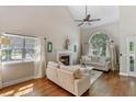 Bright living room featuring a fireplace, hardwood floors, and a large window at 339 Mount Royall Dr, Mount Pleasant, SC 29464