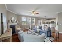 Open living room featuring a fireplace, hardwood floors, and lots of natural light at 364 Deep River Rd, Summerville, SC 29486