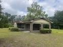 Charming brick home featuring a lattice trimmed covered front porch and a well-maintained lawn at 379 Chestnut Rd, Walterboro, SC 29488