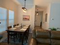 Cozy dining room featuring modern lighting, a dining table, and hardwood floors at 3808 Tupelo Branch Row, Mount Pleasant, SC 29429