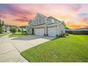 Spacious home with an attached three-car garage and well-maintained lawn at 438 Flat Rock Ln, Summerville, SC 29486