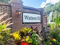 Welcoming Watson Hill community entrance sign surrounded by colorful flowers and lush greenery under a bright sky at 4407 Palm Shadow Dr, Summerville, SC 29485