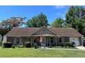 Charming single story brick home with covered porch, flower garden, attached garage and well manicured lawn at 4504 Winterwood Pl, Ladson, SC 29456