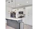 Stylish kitchen featuring a center island, white cabinetry, stainless appliances, and pendant lighting at 515 Purple Finch Rd, Summerville, SC 29486