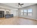 Open-concept living space with modern finishes, wood flooring, and large windows at 515 Purple Finch Rd, Summerville, SC 29486