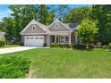 Charming single-Gathering home with an attached two car garage and well-manicured lawn at 6016 Wild Azalea Rd, Summerville, SC 29483